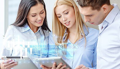 Three people holding tablets, looking at them; Dashboard visualisation hovers over the displays